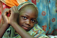 A Darfur refugee girl waits to be registered at Gaga refugee camp in eastern Chad in May 2006