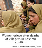 Women grieve after deaths of villagers in Kashmir conflict.