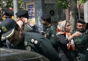 Iranian policemen warn women about their clothing and hair during a crackdown to enforce Islamic dress code in Tehran, April 2007. A group of prominent MPs have called for the Italian clothing retailer Benetton to quit Iran, saying its fashions are a bad influence on female consumers.(AFP/File)