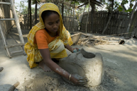 Sahena Begum makes a portable clay oven, which can be easily stored in a high place away from floodwaters. 
<BR>OXFAM/Amin 