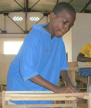 A girl from the DRC, abandoned by her family, learns carpentry as a way to make a living. Credit: David Hecht/IRIN