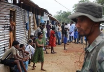 A Sri Lankan soldier stands guard in a transit camp for internally displaced