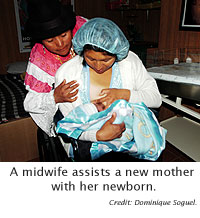 A midwife assists a new mother with her newborn.
