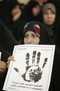 An Iraqi woman holds a banner that reads  