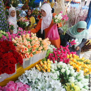 Women at flower stall (AP Images)