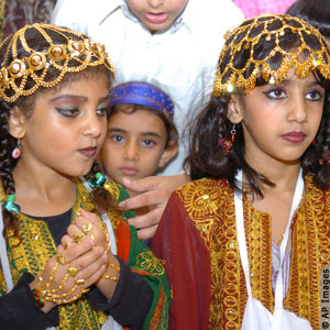 children in embroidered outfits and headdresses (AP Images)