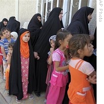 Girls and women who are orphaned or widowed by violence line up for clothing in the Shiite enclave of Sadr city in Baghdad, Iraq, 09 Sep 2009