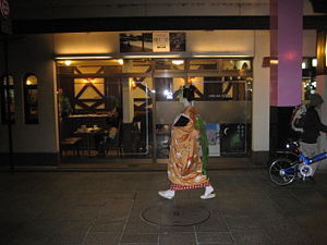 A maiko walks to her next appointment in Gion Kobu, Kyoto.