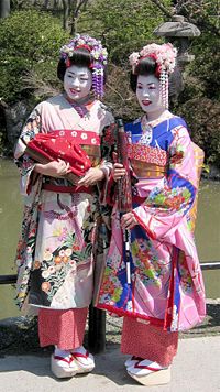 Women posing as maiko (geisha apprentices), Kyoto, Japan wearing traditional furisode and okobo