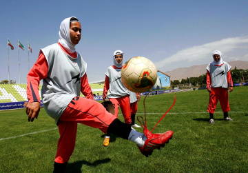 In this file picture , unidentified Iranian female national soccer players attend in a training session in Tehran, Iran.