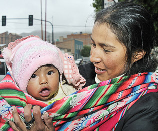 Young mother with baby in a baby-sling, Bolivia - Copyright: Kopp_Florian/Still Pictures