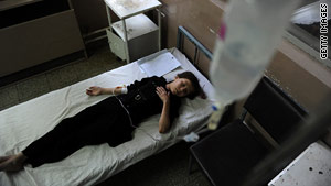 An Afghan schoolgirl suffering from suspected poisoning receives treatment Wednesday at a hospital in Kabul.