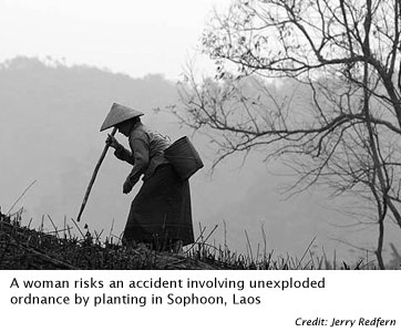 A woman risks an accident involving unexploded ordnance by planting in Sophoon, Laos