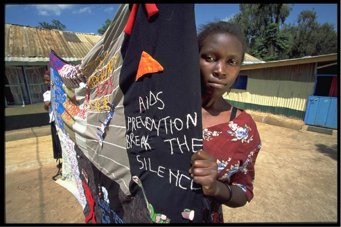 Young woman with AIDS banner, Kibera slum, Kenya