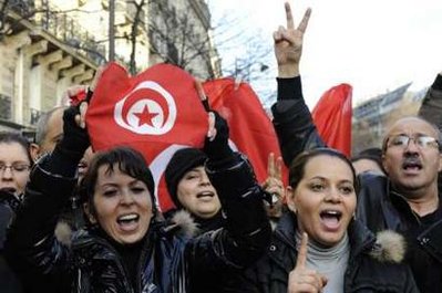Tunisian people living in France attend a protest ...