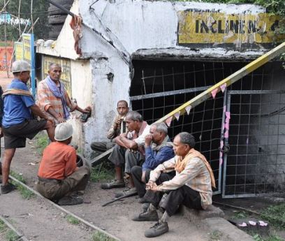India - Coal miners outside mine entrance