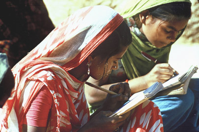 Two young mothers learning to write in a literacy class conducted by Literacy House at a village near Lucknow, in India.