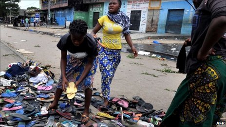 Women gather rubber sandals abandoned by women protesters shot on by troops in the Abobo neighbourhood of Abidjan, 3 March 2011.
