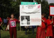 Campaigners hold a poster of Maria Isabel Franco, who was murdered in 2001
