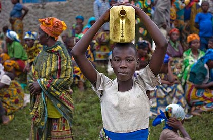 A girl waits for aid to be distributed at a village in eastern Congo. In this war-ravaged nation, it is safer to be a soldier than a woman.