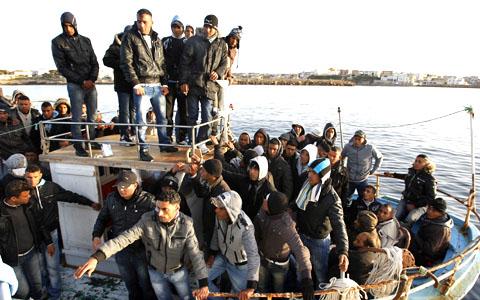 Migrants from North Africa arrive in the southern Italian island of Lampedus, March 7, 2011