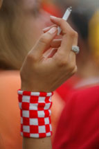A womans hand holding a cigarette