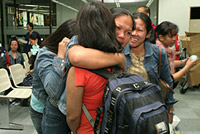 Filipino migrant workers are reunited with their families following conflict in Lebanon in 2006. © IOM Photo/Angelo Jacinto