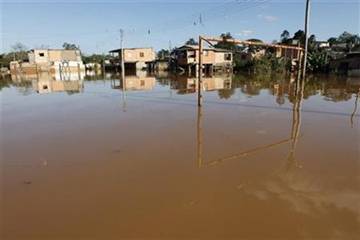 The goal posts at a flooded soccer field is seen after flood waters receded in the Ribeira do Iguape riverside suburb of Registro, 300km (186 miles) south of Sao Paulo August 5, 2011. REUTERS/Paulo Whitaker