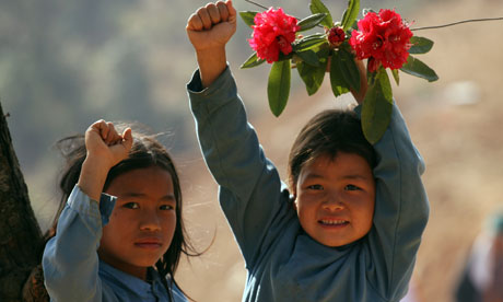 Nepalese girls give a Maoist salute during celebrations  