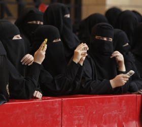 (Photo: Reuters)<br>Saudi women take photos of a military band performing in the capital of Riyadh.