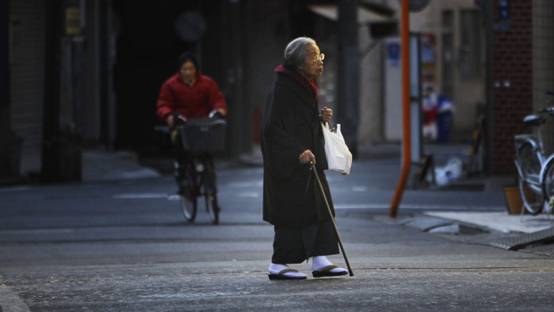 In this Jan. 22, 2011 file photo, a kimono-clad elderly woman walks across a street in Tokyo. Japan's rapid aging means the national population of 128 million will shrink by one-third by 2060 and seniors will account for 40 percent of people. - In this Jan. 22, 2011 file photo, a kimono-clad elderly woman walks across a street in Tokyo. Japan's rapid aging means the national population of 128 million will shrink by one-third by 2060 and seniors will account for 40 percent of people. | Junji Kurokawa/AP