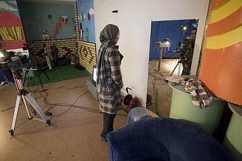 Bahar Jooya prepares herself for a live program at a private TV studio in Herat, Dec. 2009 (file photo).