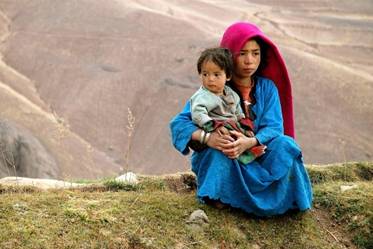 A young Afghan girl with her child