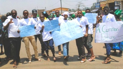 Men from 'A Common Future' Cameroon wear women's high-heels during a protest