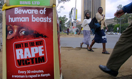 MDG : Rape in Kenya : People walk past a poster bearing a message against rape on street of Nairobi