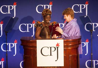 Mae Azango receives an award from AP Executive Editor Kathleen Carroll