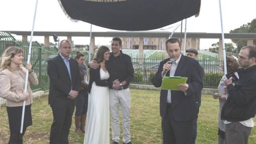 Rabbi Gilad Kariv, the head of the Reform movement in Israel performs a Reform Jewish wedding ceremony in front of the Knesset, March 18, 2013, in protest of the Orthodox Rabbinate's monopoly on marriage licensing and the lack of civil marriages in Israel. To the left of the couple stands Labor party MK and secretary-general Hilik Bar (photo credit: Flash90)