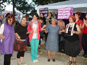 Filmmor's protest area before the police broke up the demonstration: a group of women holding hands in front of a pavilion