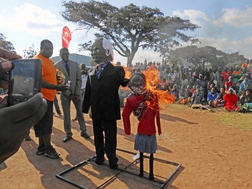Zambian husband and child bride burned in symbolic effigy before a small village in the Eastern Province of Zambia