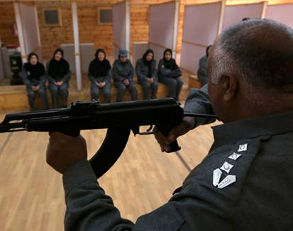 Afghan policewomen receive instruction on shooting at the Afghan National Police Academy shooting range in Kabul December 9. Afghan militants have been targeting female police officers, officials say. [REUTERS/Omar Sobhani]