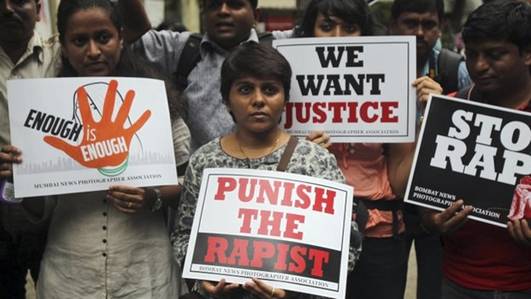 Photojournalists hold placards as they protest against the gang rape of a 22-year-old woman photojournalist in Mumbai India, Friday, Aug 23, 2013.