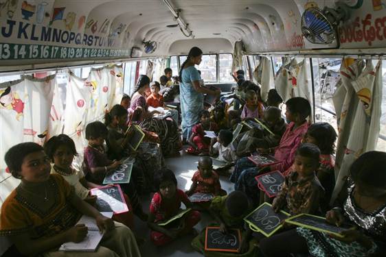 Image: Children write letters inside a bus converted into a school in the southern Indian city of Hyderabad.