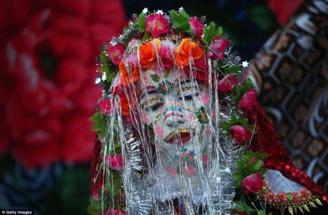 Here comes the bride: Fatme Inus, her face painted white and decorated with sequins, emerges to present herself to villagers