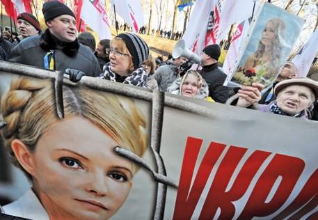 People hold a giant portrait of jailed Ukrainian opposition leader and former prime minister Yulia Tymoshenko on Nov, 27 during a rally of opposition supporters in Kyiv in front of the government headquarters. 