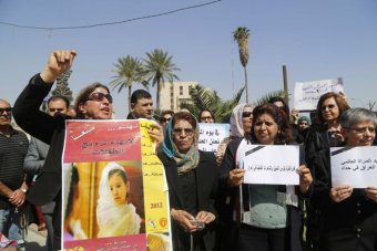 Iraqi women protest against a proposed Islamic law with signs in Baghdad