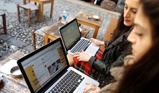Two Turkish women try to get connected to the Twitter web site with their laptops at a cafe in Istanbul, Turkey 21 March 2014.