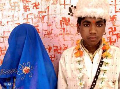 Soram Bai, 11, and her groom Bheeram Singh, 16, stand pose for photographs at the Jalpa Mata Temple after their marriage ceremony in Rajgarh district, about 155 kilometers (96 miles), northeast of Bhopal, India, (AP Photo/Prakash Hatvalne)