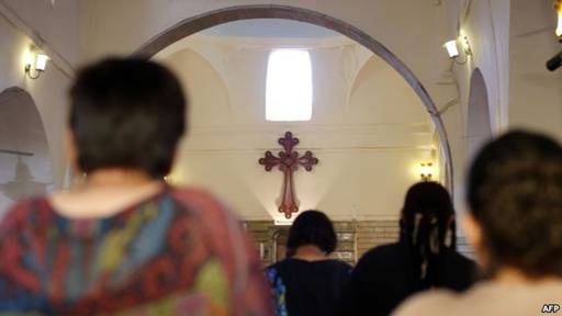 Iraqi Christians fleeing the violence in the towns of Qaraqush and Bartala, both east of the city of Mosul in the northern province of Nineveh, pray at the St. George Church in the Kurdish autonomous region's capital, Irbil.