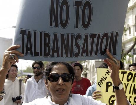 Human rights activist holds a placard during an anti-Talibanisation protest in Lahore