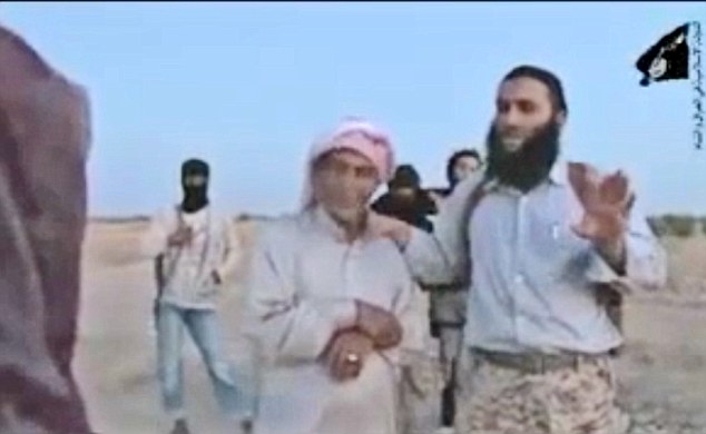 Terror: The bearded ISIS militant orders the woman to be 'content and happy' that she is about to be stoned to death because, he says, her death has been ordered by God. Her father (left) stands next to the extremist